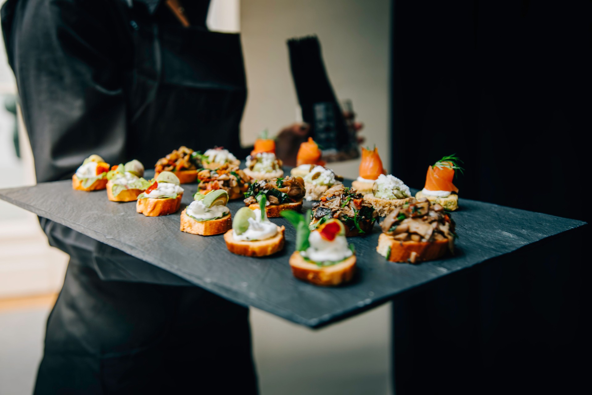 Elegant Selection of Canapés on a Slate Serving Tray